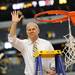 Michigan head coach John Beilein waves the crowd as he prepares to cut the net down after Michigan beat Florida to win the NCAA South Regional Championship and advance to the Final Four at Cowboys Stadium on Sunday, March 31, 2013. Melanie Maxwell I AnnArbor.com